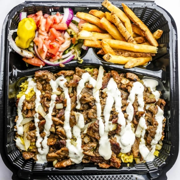 Zalim Hot Chicken & Burgers' beef and rice platter with fries and salad in a black takeout container.